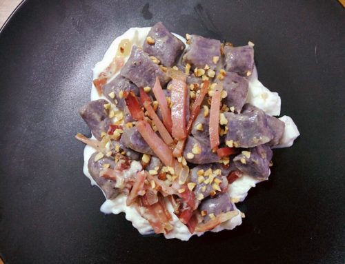 Gnocchi di patate viola con speck e granella di nocciole su letto di squacquerone